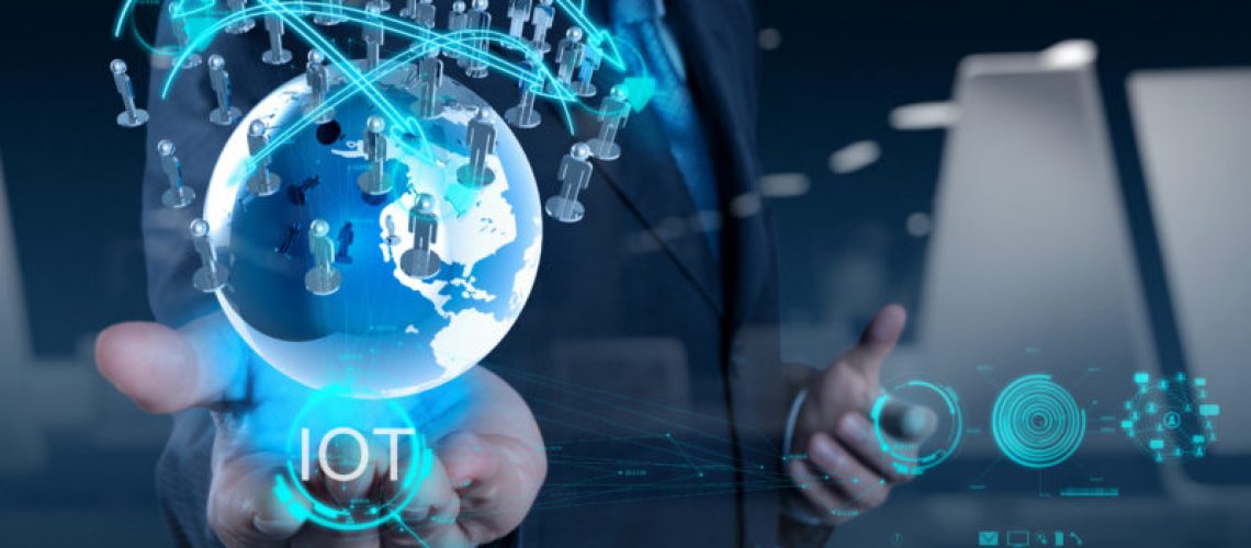 double exposure of hand showing Internet of things (IoT) word diagram as concept